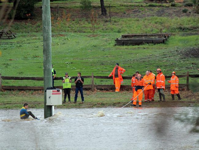 A 15-year-old boy stranded on an inundated cricket oval at Tynwald Park in New Norfolk during the flood. Picture: DAMIAN BESTER