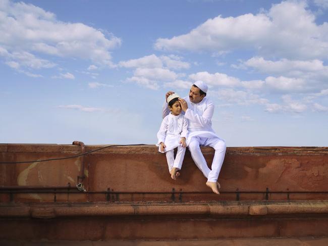 Bridging Generation. A beautiful photo of a father and son sitting in white traditional attire with beautiful blue sky on the day of Eid al-Fitr in a mosque in New Delhi, India. The photo shows the beautiful bond which these two generation have been building up in a very simple and lovable manner. Picture: Jobit George / National Geographic Travel Photographer of the Year