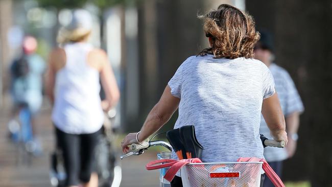 Cyclist wearing no helmet on the shared path at Manly.