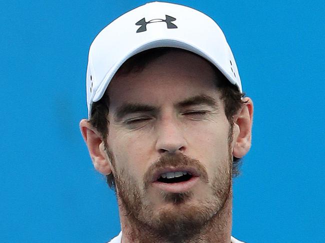 Andy Murray tentative on his right foot during his practice session with Milos Raonic which was cut short due to rain, Brisbane International Tennis. Photographer: Liam Kidston.