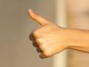 Generic image of a hitchhiker sticking out thumb on empty country road.