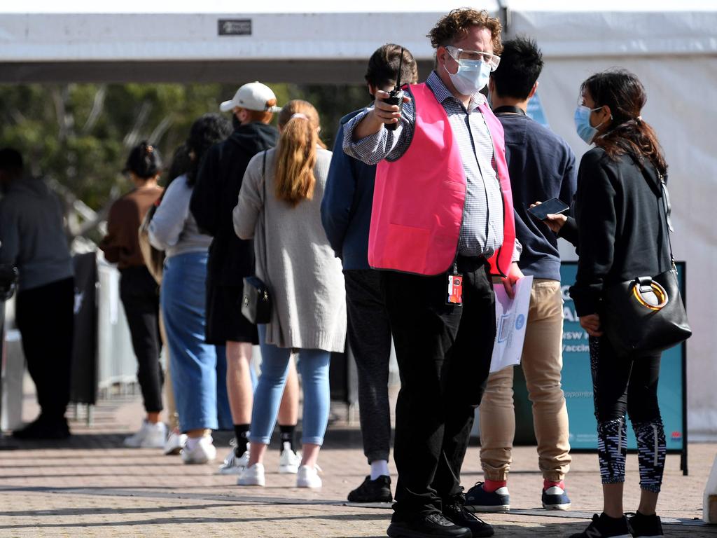 Students wearing face masks wait in a queue to receive their first dose of the Pfizer Covid-19 vaccine in Sydney. Picture: AFP