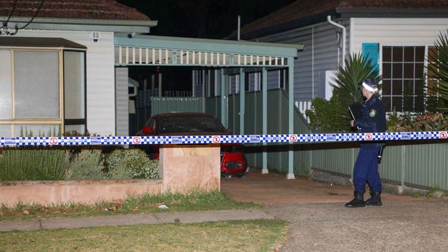 A Bankstown police officer checking out the house. Picture: Dean Asher