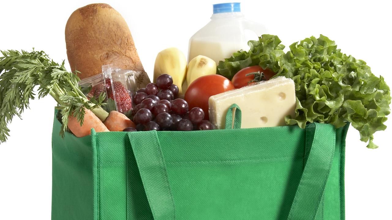 A reusable/recyclable grocery bag filled with fresh groceries. Be Green!