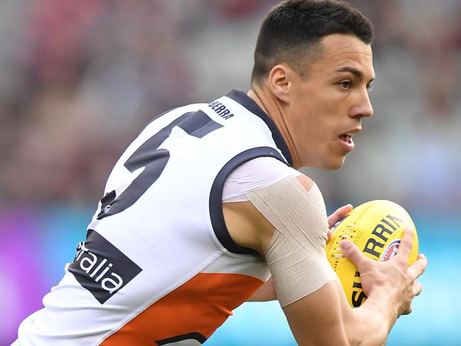 Dylan Shiel of the Giants controls the ball during the Round 23 AFL match between the Melbourne Demons and the Greater Western Sydney (GWS) Giants at the MCG in Melbourne, Sunday, August 26, 2018. (AAP Image/Julian Smith) NO ARCHIVING, EDITORIAL USE ONLY