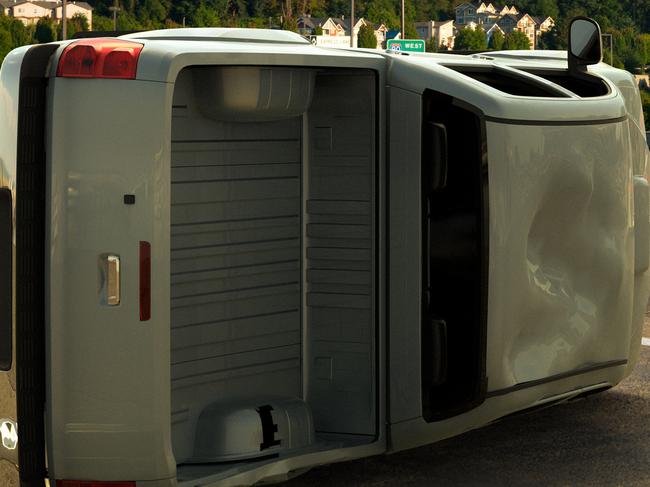 3D rendering of a car accident with a van tipped over and emergency vehicles approaching.