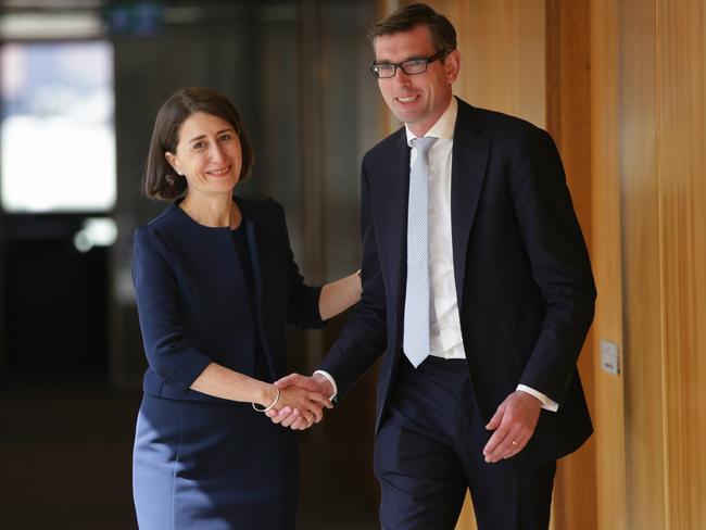 Ms Berejiklian shakes hands with new Treasurer Dominic Perrottet after they were both unanimously elected. Picture: Toby Zerna