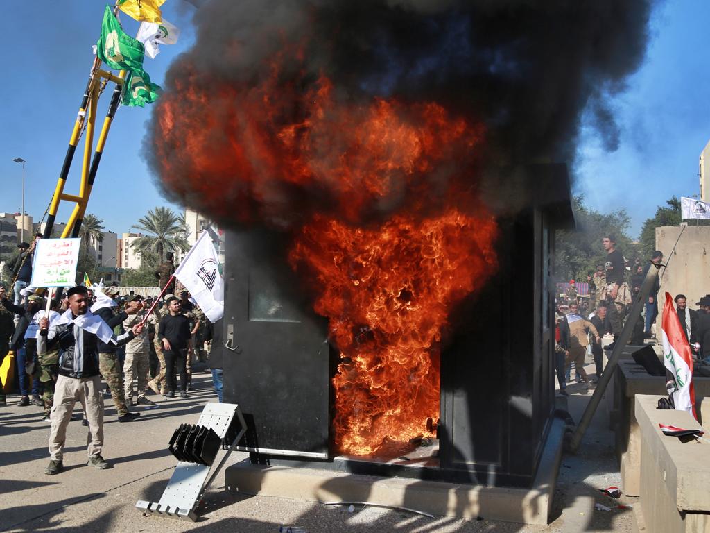 Protesters burn property in front of the US embassy compound, in Baghdad, Iraq. Picture: AP