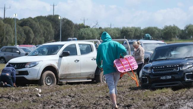 Dozens of cars were eventually retrieved from the muddy paddocks. Picture: Mark Wilson