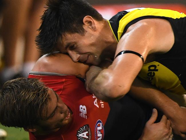 Trent Cotchin of the Tigers (right) and Jack Viney of the Demons fight during the Round 5 AFL match between the Richmond Tigers and the Melbourne Demons at the MCG in Melbourne, Monday, April 24, 2017. (AAP Image/Julian Smith) NO ARCHIVING, EDITORIAL USE ONLY