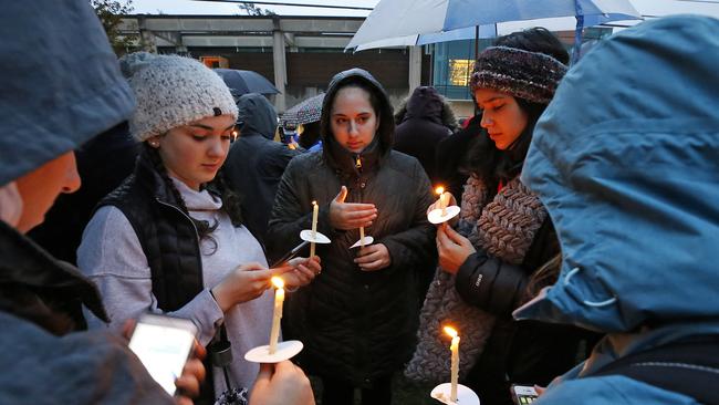 A group of girls wait for the start of a memorial vigil for the victims of the Pittsburgh shooting. Picture: AP