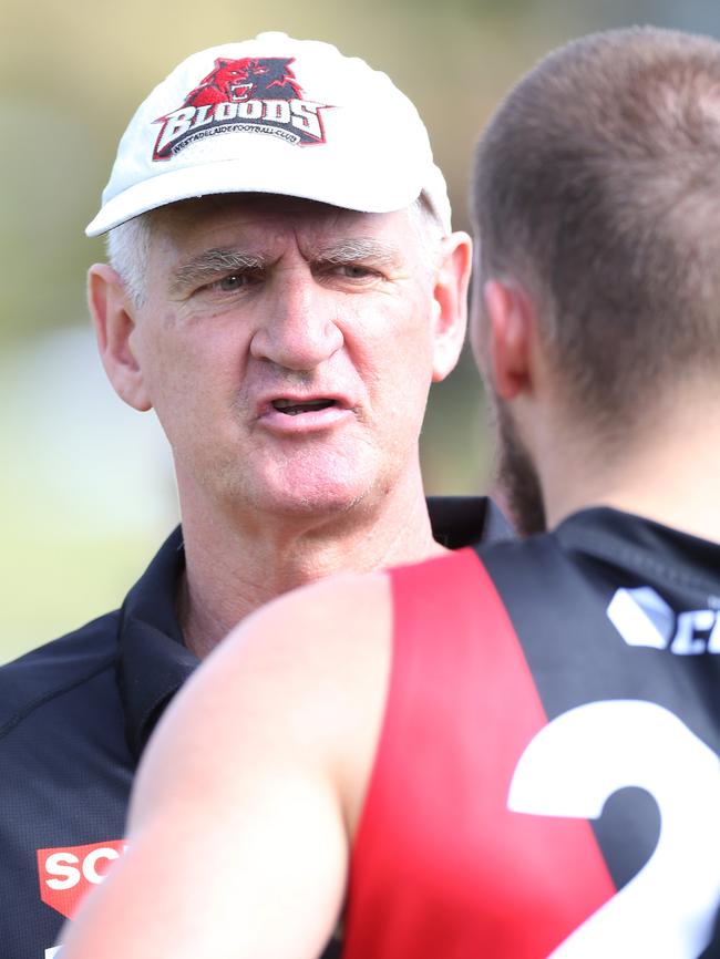 Mark Mickan during a quarter-time break with his players.