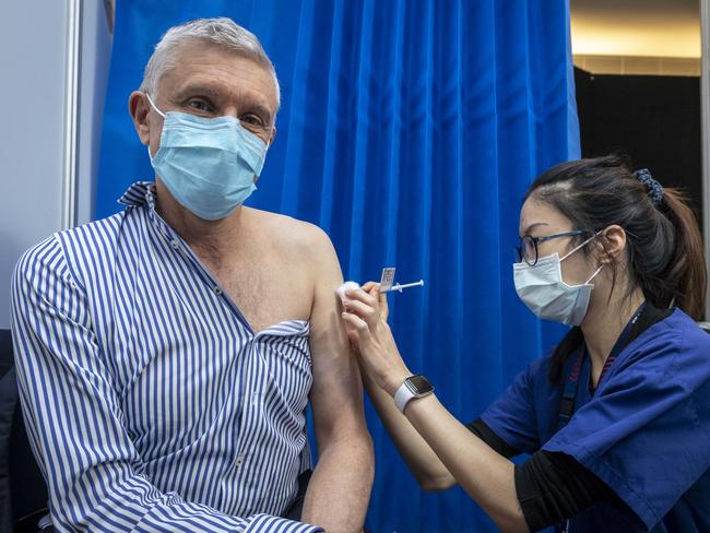 There are concerns some cancer patients are holding off having the COVID-19 vaccination when they should not be. Prof Grant McArthur who is one of the top oncologists, as well as being a prostate cancer survivor receives a Covid vaccine from nurse Serena Lin. Picture: Jake Nowakowski