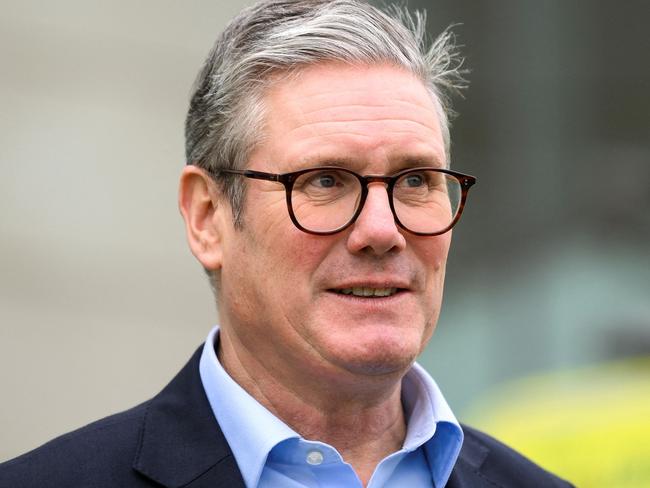 Britain's Prime Minister Keir Starmer reacts as he speaks with members of staff of Ambulance Service, outside of London ambulance service dockside centre, in London, on October 21, 2024, during a visit. (Photo by Jaimi Joy / POOL / AFP)