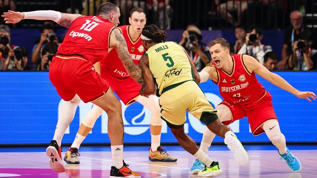 Patty Mills is surrounded during Australia’s defeat to Germany. (Photo by Takashi Aoyama/Getty Images)