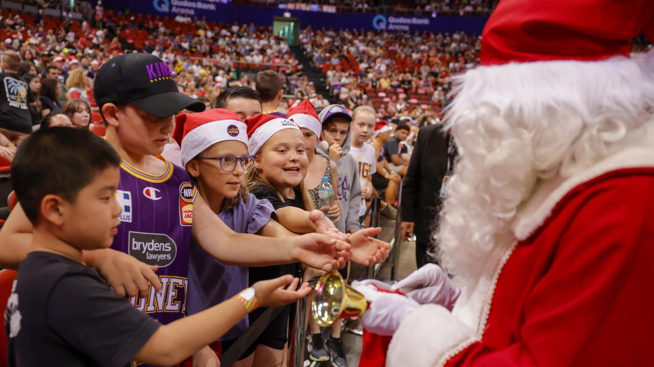 Santa hands out presents to kids during the round 12 NBL match between Sydney Kings and Melbourne United at Qudos Bank Arena, on December 25, 2022, in Sydney, Australia. (Photo by Jenny Evans/Getty Images)