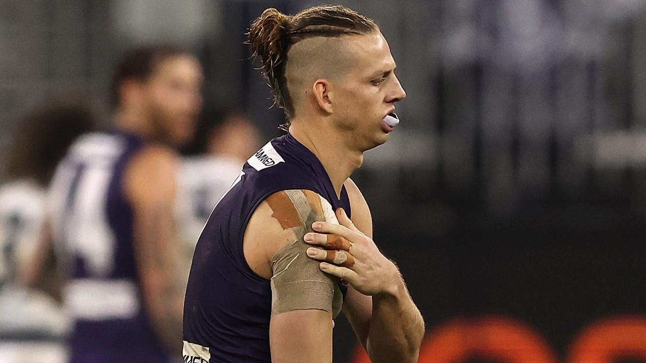 PERTH, AUSTRALIA - JULY 15: Nat Fyfe of the Dockers holds his injured shoulder during the round 18 AFL match between the Fremantle Dockers and Geelong Cats at Optus Stadium on July 15, 2021 in Perth, Australia. (Photo by Paul Kane/Getty Images)