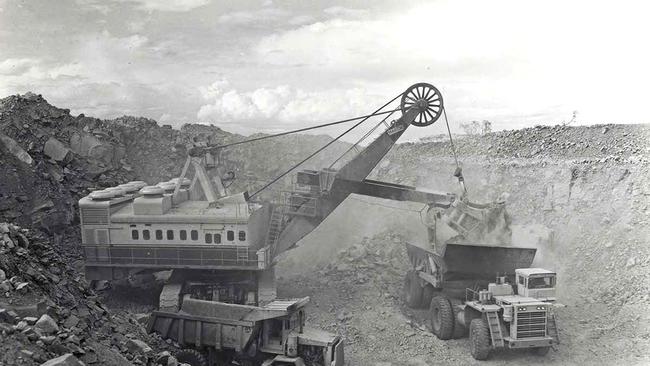 A giant power shovel and 95-ton trucks working on the Hamersley railway in 1966, which was required to transport the large deposits of iron ore discovered in the Pilbara region of Western Australia. Picture: National Museum of Australia