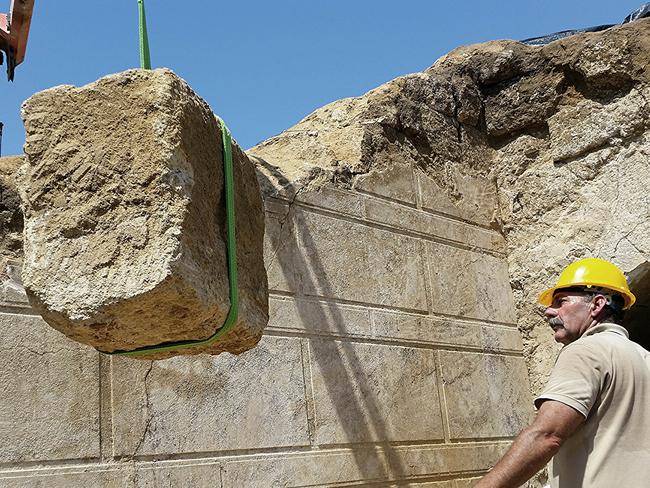 Block by block ... In this handout photo released by the Greek Culture Ministry, workers remove one of the large stone blocks from a wall originally sealing the entrance to an ancient tomb under excavation at Amphipolis in northern Greece. Source: AP