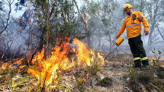 Parks and Wildlife fire crew supervisor James Shaw starts fires during a controlled burn on Crown Land at Risdon Vale in 2014.