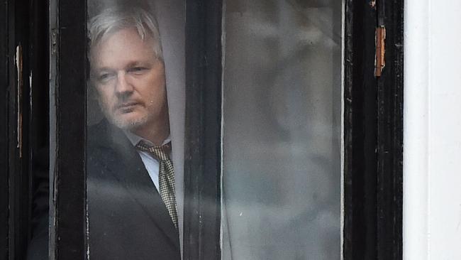 WikiLeaks founder Julian Assange comes out on the balcony of the Ecuadorean embassy in 2016. He is fighting extradition to the US. Picture: AFP.