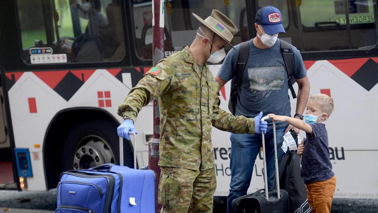 Returning overseas travellers are ushered into the Intercontinental Hotel in Sydney for their 14-day quarantine on Sunday. Picture Jeremy Piper/AAP