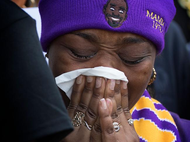 Fans who were unable to get tickets, react as they watch the memorial outside the Staples Center in Downtown Los Angeles. Picture: AFP