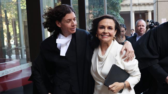 Sue Chrysanthou SC hugs Lisa Wilkinson as they emerge from court on April 15, 2024 in Sydney.