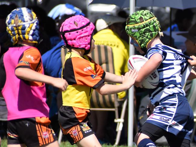 Herbert River Junior Rugby League Crushers Orange U8 player Aston Bye tackles an opponent from Townsville Brothers. Photographs from the Dean Schifilliti Shield rugby league carnival for U8 players at Artie Gofton Oval, Ingham, Hinchinbrook Shire, on Saturday: Pictures: Cameron Bates