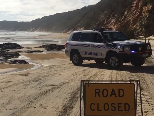 Rainbow Beach's Ice Man captured images of the police blockade at Double Island Point on Friday, January 5, 2024, after a massive landslide dumped tonnes of trees, rocks, and sand across the popular tourist beach.