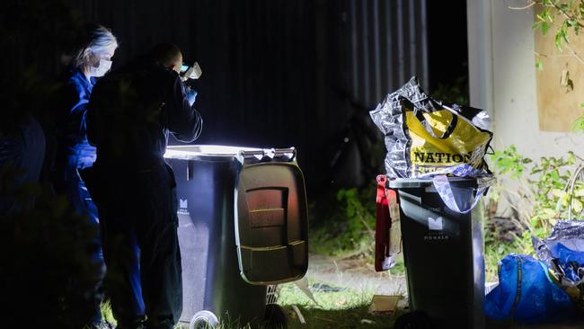 Missing Persons Squad detectives and forensics at a crime scene along Railway Parade Chadstone and also at a property on Binalong Avenue, Chadstone. Police look through a garbage bin. Picture: Jason Edwards