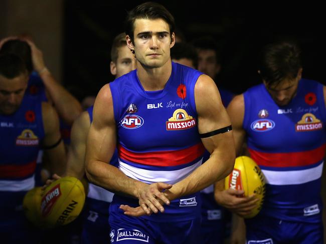 MELBOURNE, AUSTRALIA - APRIL 23: Easton Wood of the Bulldogs leads his team out onto the field during the round five AFL match between the Western Bulldogs and the Brisbane Lions at Etihad Stadium on April 23, 2016 in Melbourne, Australia. (Photo by Quinn Rooney/Getty Images)