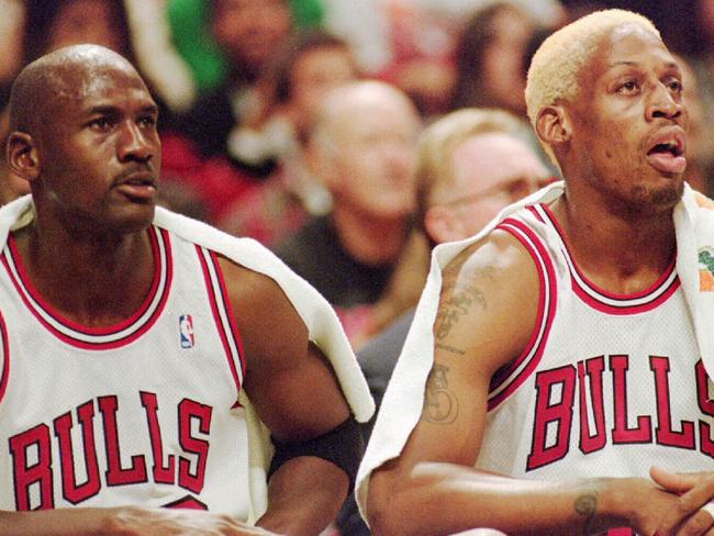 Chicago Bulls' Michael Jordan, left, and Dennis Rodman rest on the bench as they watch their teammates play the Washington Bullets during the first quarter Tuesday night, Oct. 17, 1995, in Chicago. (AP Photo/Fred Jewell). Basketball