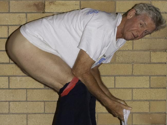 Andrew Douglas Macintosh was charged with public nuisance after Greenslopes residents snapped off a shot of  the jogger defecating on their pathway.