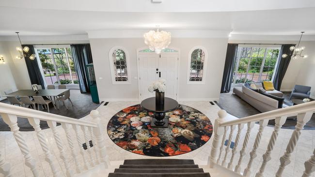 The grand entrance leads to formal living and dining rooms downstairs and bedrooms upstairs.