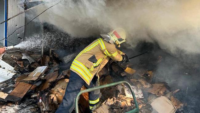 A firefighter on Saturday puts out a blaze in a market in Bakhmut in the Donetsk region after Russian shelling. Picture: AFP