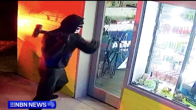 A masked man smashes his way into a tobacconist on Myall Rd, Tea Gardens on March 16, 2024. An ATM was stolen. Picture: NBN News.