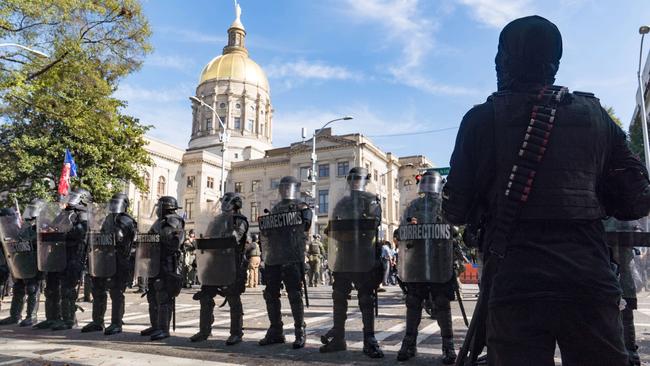 Police stand between protesters and counter-protesters outside the Georgia State Capital building in Atlanta over the weekend. Picture: Getty Images/AFP