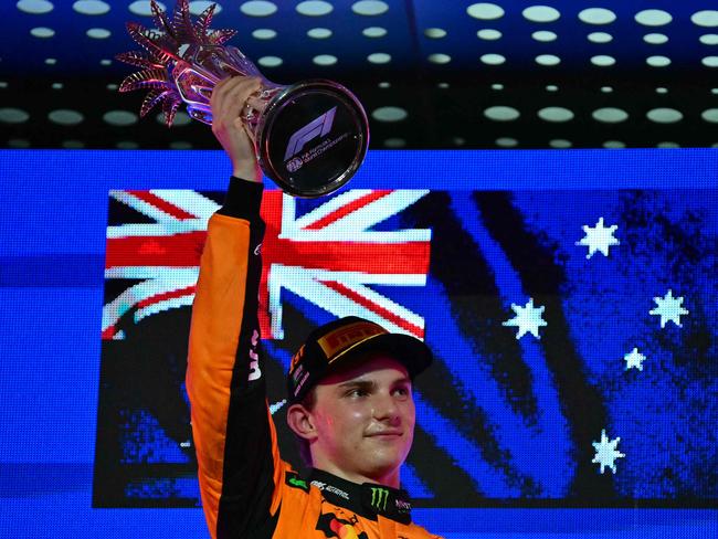 Oscar Piastri lifts the trophy as he celebrates on the podium after the 2025 Saudi Arabia Formula One Grand Prix. Picture: AFP
