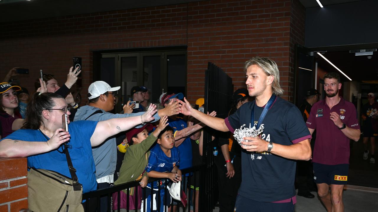 IPSWICH, AUSTRALIA - SEPTEMBER 29: Kai Lohmann celebrates with fans at Brighton Homes Arena, on September 29, 2024, in Ipswich, Australia. The Brisbane Lions won the 2024 AFL Grand Final yesterday beating Sydney Swans at the MCG. (Photo by Bradley Kanaris/Getty Images)