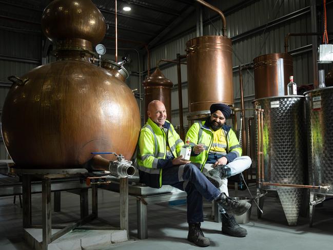 Former senator Stephen Parry and head distiller Raj Charan Singh with a bottle of their Section 44 gin at their distillery in Hob. Picture: Peter Mathew