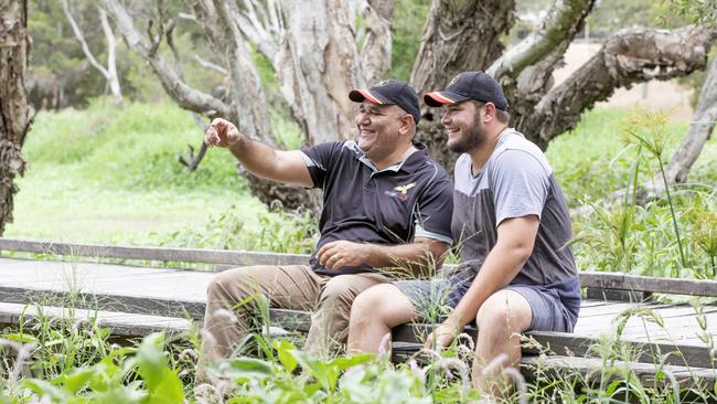 Aboriginal man Dr John Davis, left, is concerned traditional lands will be used for a road without indigenous approval and at the expense of an indigenous community. He is pictured at Eagleby Wetlands with Geoffrey Mount. AAP/Renae Droop