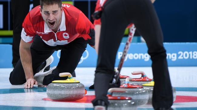 Canada's John Morris shouts instructions as Kaitlyn Lawes brushes the ice surface in their semi-final against Norway. Picture: AFP