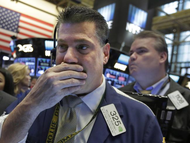 Trader William McInerney, left, works on the floor of the New York Stock Exchange, Wednesday, April 20, 2016. U.S. stock indexes are narrowly mixed in early trading on Wall Street as investors absorb the latest round of company earnings reports. (AP Photo/Richard Drew)