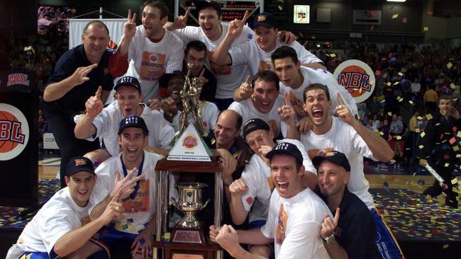 Adelaide 36ers players and coaching staff celebrate their 2002 NBL grand final victory over West Sydney Razorbacks, the SA club’s last championship success.