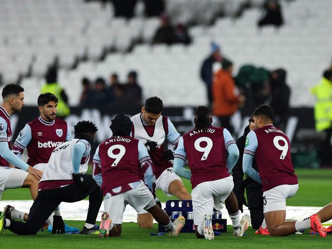 West Ham United's team-players wear the shirt of his teammate West Ham United's English forward #09 Michail Antonio as part of tribute following his car accident, during the warm-up prior to the English Premier League football match between West Ham United and Wolverhapton Wanderers at the London Stadium, in London on December 9, 2024. West Ham said forward Michail Antonio has undergone surgery on a lower limb fracture after a serious car accident on December 7, 2024. (Photo by Adrian Dennis / AFP) / RESTRICTED TO EDITORIAL USE. No use with unauthorized audio, video, data, fixture lists, club/league logos or 'live' services. Online in-match use limited to 120 images. An additional 40 images may be used in extra time. No video emulation. Social media in-match use limited to 120 images. An additional 40 images may be used in extra time. No use in betting publications, games or single club/league/player publications. /