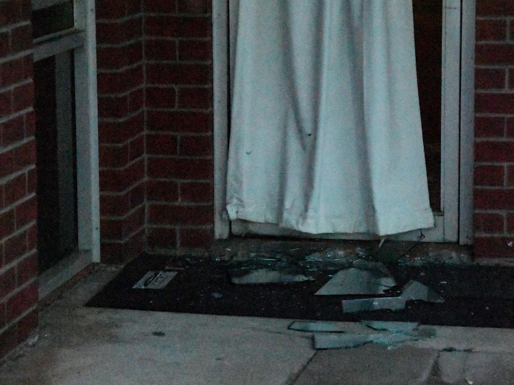 Broken glass is seen at the front of the Palms Motel. Picture: Keri Megelus