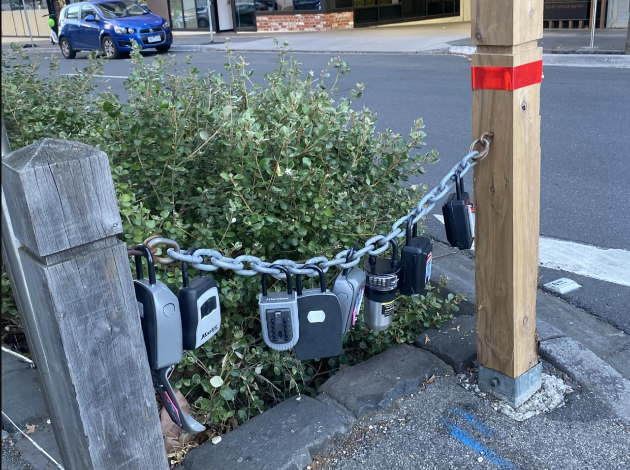 Over a dozen keypad locks are chained up across Cremorne streets, containing keys to Airbnbs in the area. Picture: Reddit