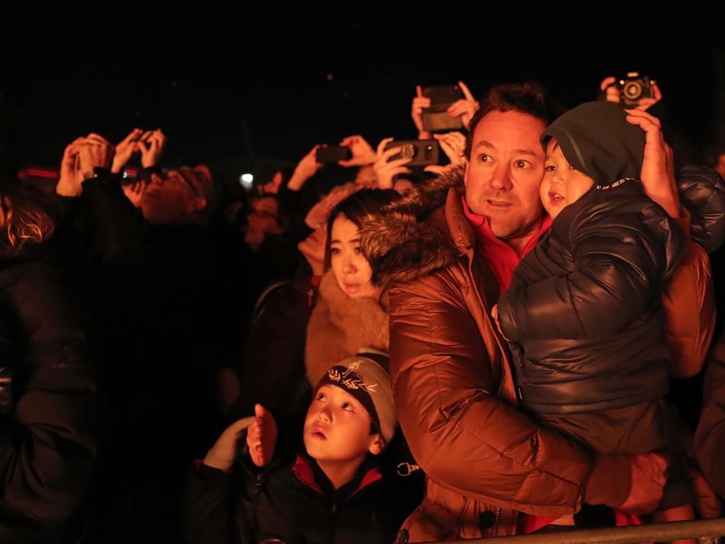 The Merrick family from Lindisfarne, Koa, 7, left, Miyami and Glenn holding Keito, 3, watching the Ogoh-Ogoh alight at The Burning at Dark Park. Picture: LUKE BOWDEN