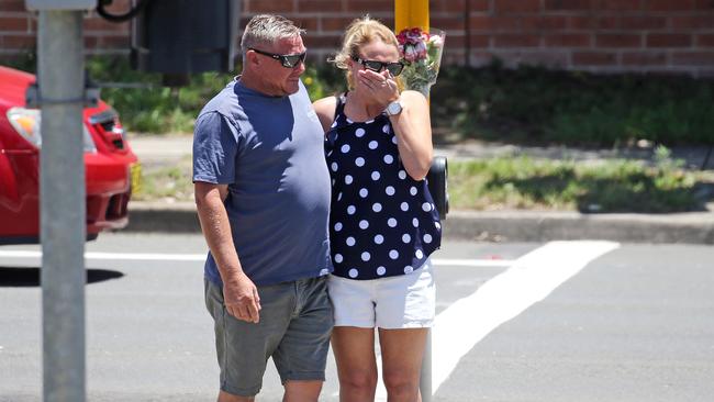 Relatives gather where the young girl was killed. Picture: Tim Hunter.